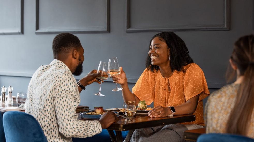 Couple clinking glasses in restaurant